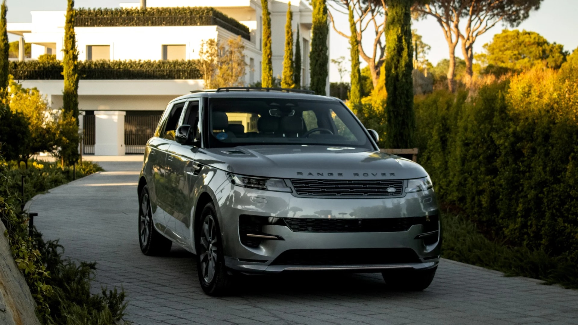 Range Rover Sport on a villa driveway at golden hour